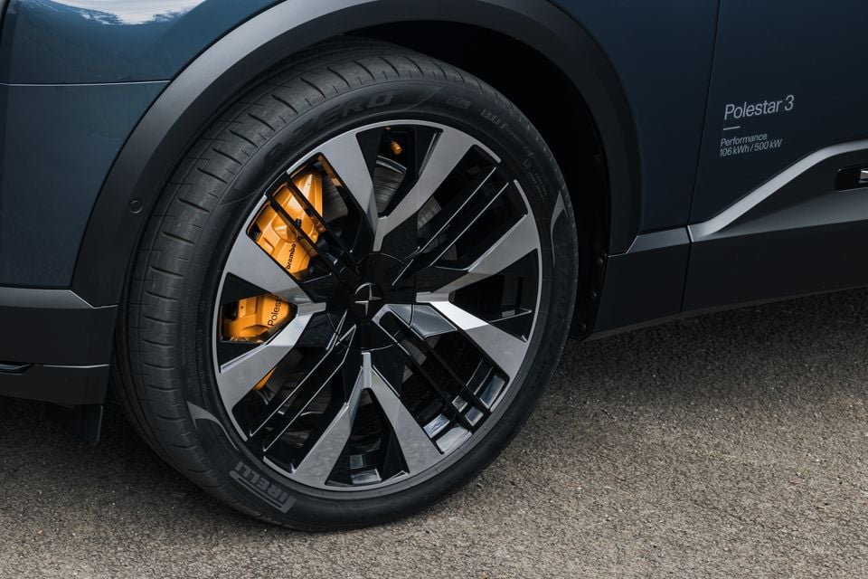 Close-up of a Polestar 3 Performance SUV wheel showing a large alloy rim with yellow Brembo brake calipers and Pirelli P Zero tyres