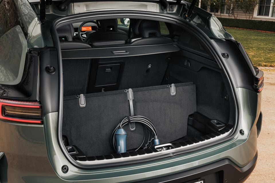Boot of a 2026 Polestar 3 SUV open, showing the cargo area with a charging cable stored inside