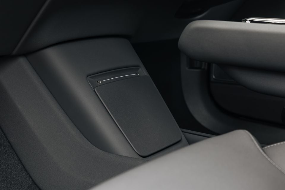 Interior rear centre console area of a 2026 Polestar 3 showing a USB-C port and storage pocket between the rear seats