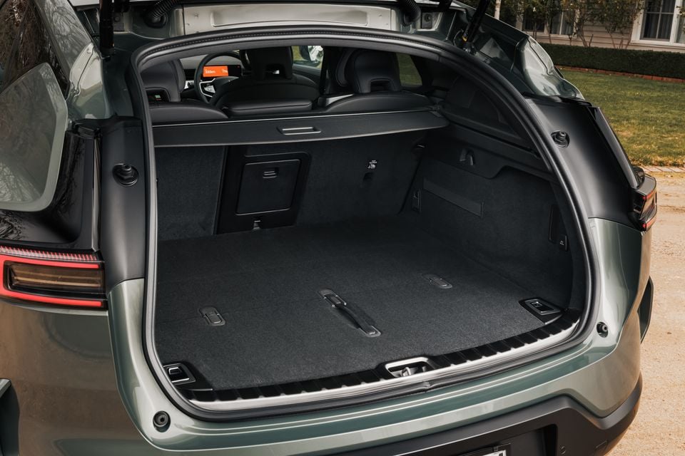 Open boot of a 2026 Polestar 3 SUV showing a spacious carpeted cargo area, viewed from the rear