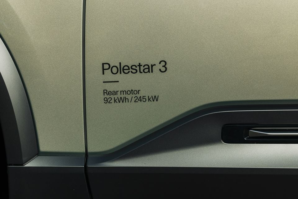 Close-up of the Polestar 3 door panel showing the 'Polestar 3 Rear motor 92 kWh / 245 kW' badge on a green-grey body.