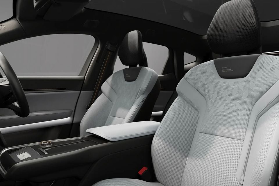 Interior of a 2026 Polestar 3 showing light grey front seats with quilted upholstery and centre console