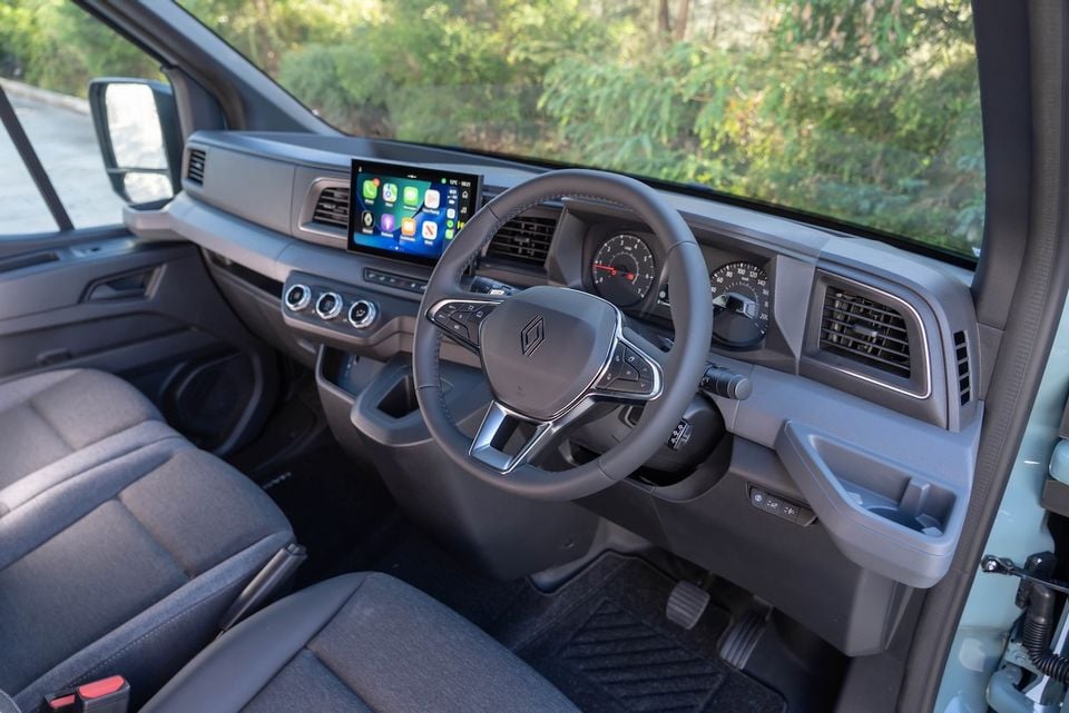 Interior of a 2026 Renault Master van showing the steering wheel, touchscreen infotainment display with Apple CarPlay, dashboard and instrument cluster from the passenger side