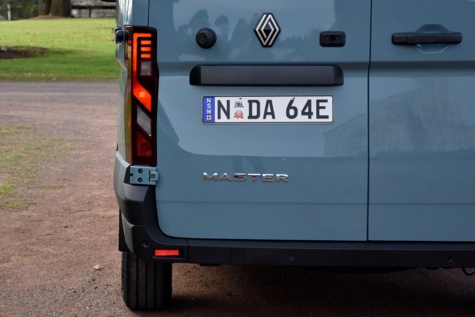 Rear of a blue 2026 Renault Master van showing the Renault badge, Master lettering, tail lights and NSW number plate