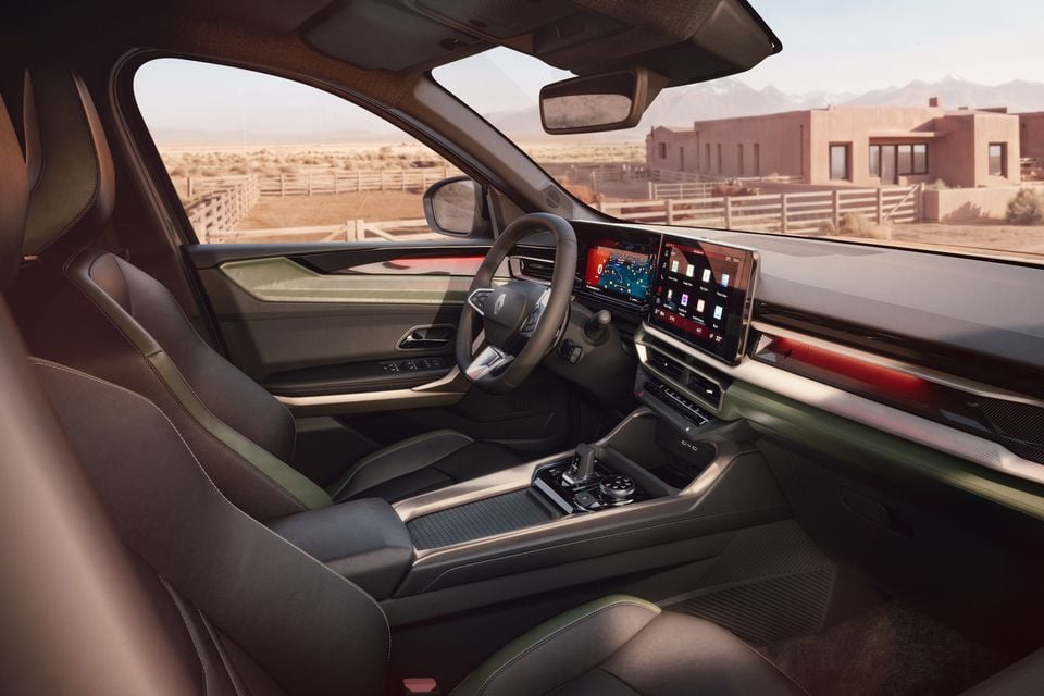Interior of the 2026 Renault Niagara showing the dashboard, large dual touchscreen infotainment display, steering wheel, centre console, and front seats with green accent trim