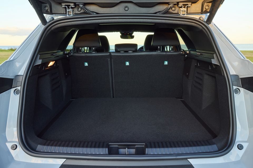 Open boot of a 2026 Renault Symbioz Esprit Alpine SUV, showing a spacious carpeted cargo area with the rear seats visible through the opening