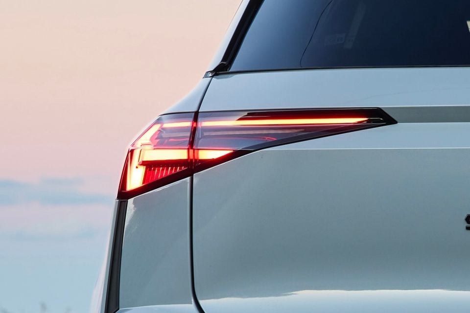 Close-up of the illuminated LED tail light on a white 2026 Renault Symbioz Esprit Alpine, seen from the rear quarter