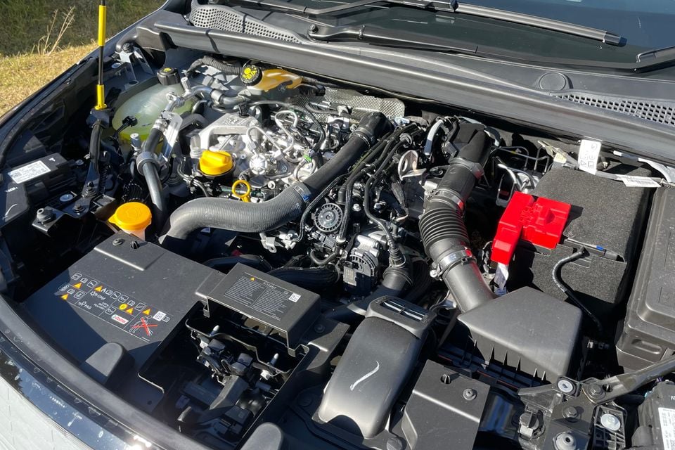 The engine bay of a 2026 Renault Symbioz mild hybrid, showing the turbocharged petrol engine, battery, and associated components with the bonnet open.