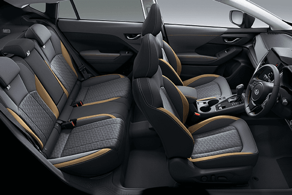 Interior view of a 2026 Subaru Crosstrek Sport Special Edition showing front and rear seats with black, grey and gold accent upholstery, centre console, and steering wheel