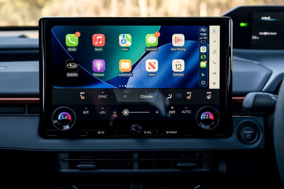 The touchscreen infotainment display of a Subaru showing Apple CarPlay with apps including Phone, Music, Maps, Messages and Podcasts, alongside climate control settings at 22.5 degrees.