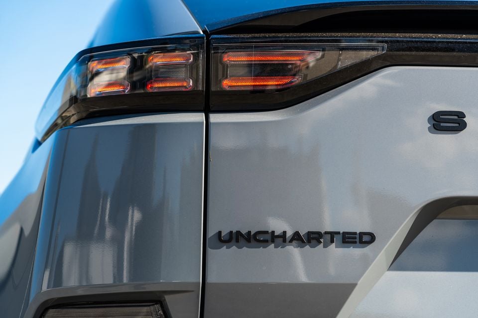 Close-up of the rear taillight and 'Uncharted' badge on a 2026 Subaru Outback Uncharted AWD in grey