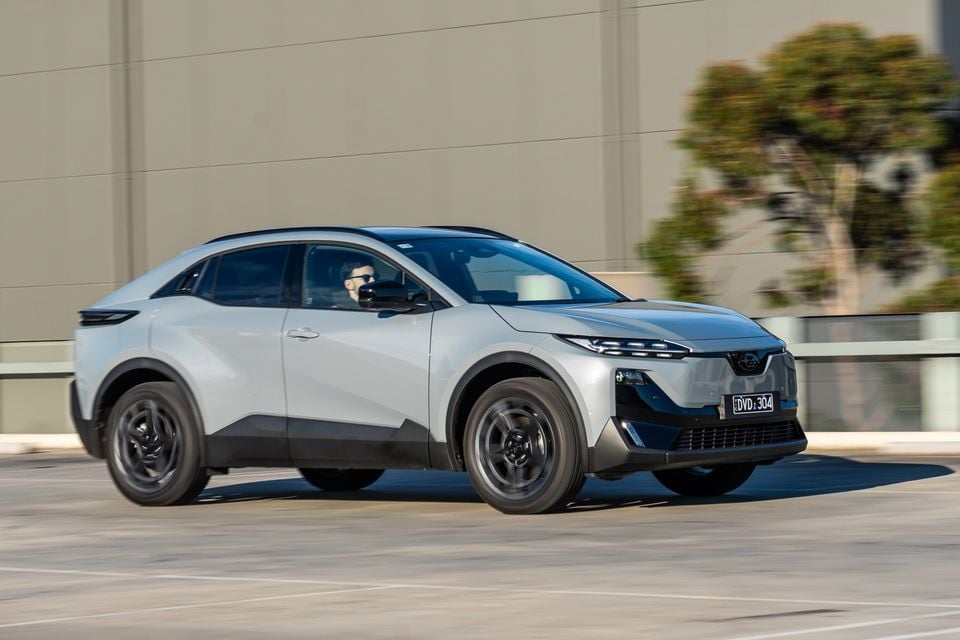 A silver 2026 Subaru Uncharted AWD SUV seen from the front-side while driving on a road