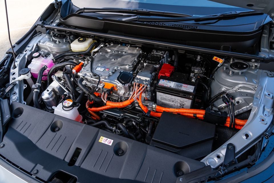 The hybrid engine bay of a Subaru Uncharted AWD, showing orange high-voltage cables and hybrid powertrain components with the bonnet open
