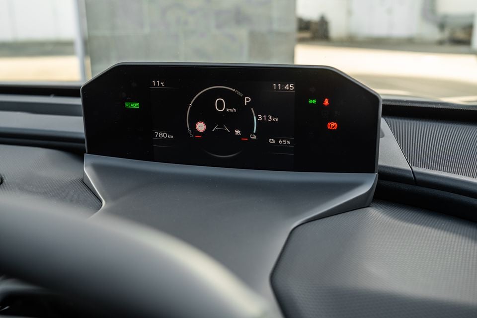 Digital instrument cluster in a 2026 Subaru electric vehicle showing speed, battery charge at 65%, and a range of 313km on the dashboard