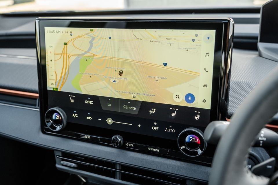 The touchscreen infotainment display in a 2026 Subaru showing Google Maps navigation of Melbourne's Docklands area, with climate control panel visible below