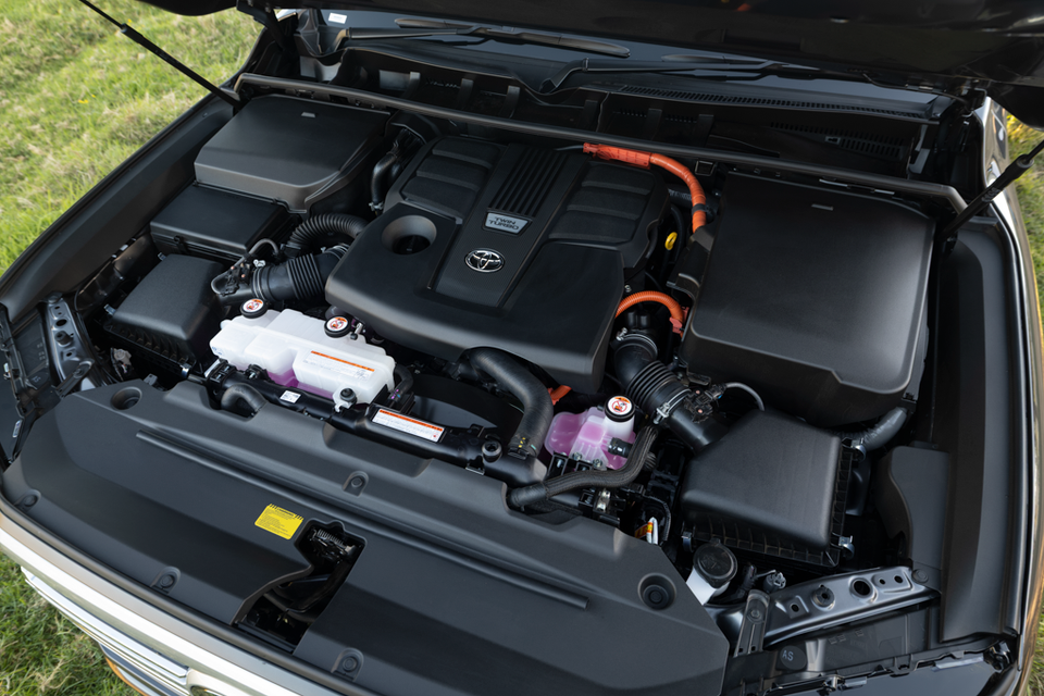 Toyota twin-turbo hybrid engine bay of a 2026 Toyota LandCruiser 300, showing orange high-voltage cables indicative of a hybrid powertrain