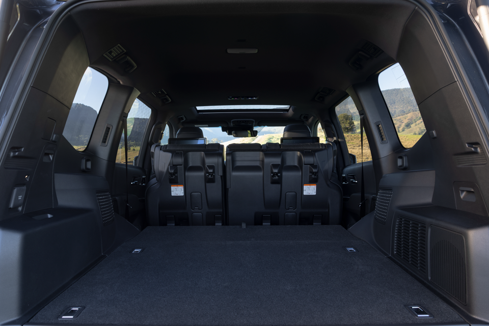 Spacious boot area of a 2026 Toyota LandCruiser 300 SUV with the third row folded, viewed from the rear with the tailgate open
