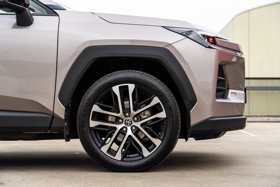 Close-up of the front wheel and alloy rim on a champagne-coloured 2026 Toyota RAV4 Cruiser SUV.