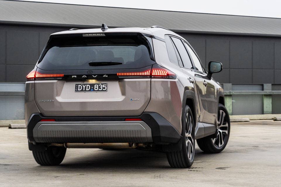 A grey 2026 Toyota RAV4 Cruiser SUV photographed from the rear quarter in a car park