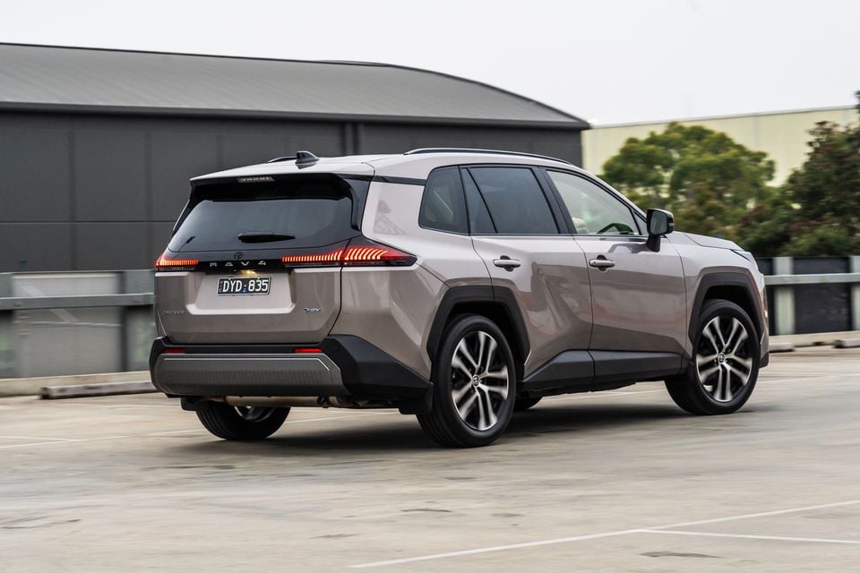 A beige 2026 Toyota RAV4 Cruiser SUV seen from the rear quarter, parked on a rooftop car park.