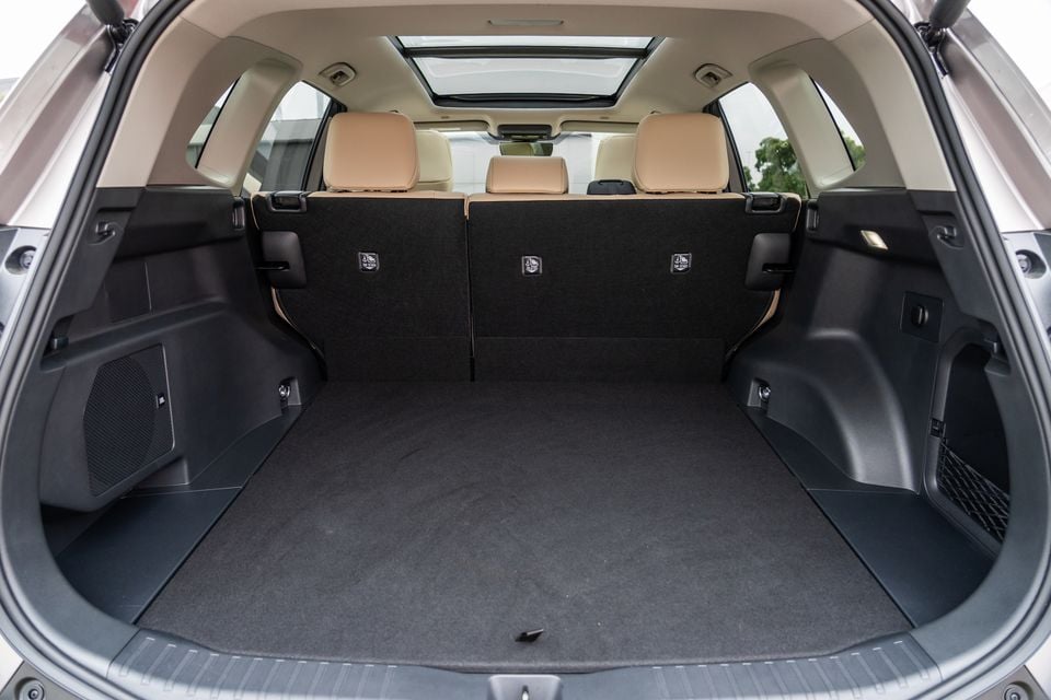 The empty cargo boot of a 2026 Toyota RAV4 Cruiser, seen with the rear seats upright and panoramic sunroof visible.