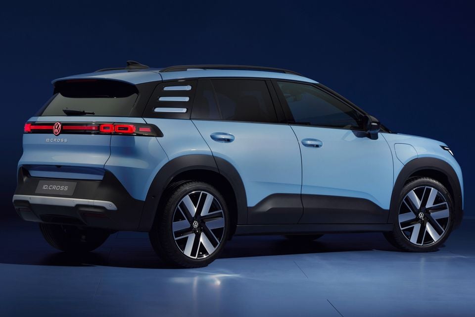 A light blue Volkswagen ID.Cross SUV seen from the rear three-quarter angle in a studio setting