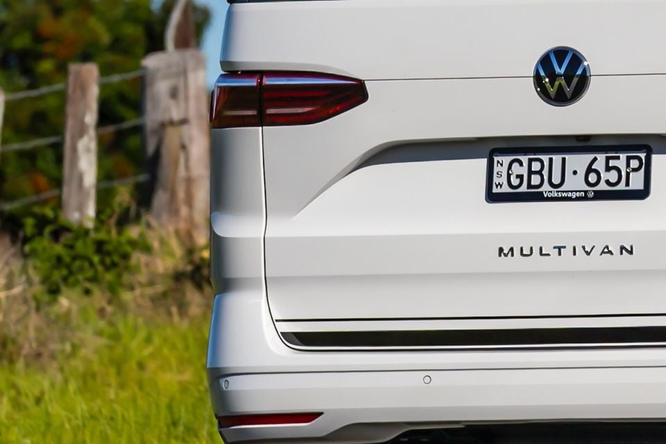 Rear of a white 2026 Volkswagen Multivan van with NSW registration plates, seen from behind outdoors