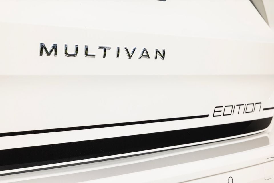 Close-up of the Multivan badge and Edition stripe graphic on a white Volkswagen Multivan Edition