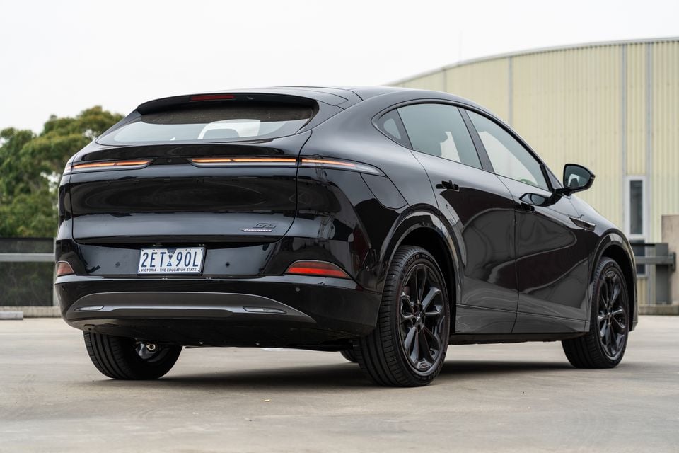 A black 2026 Xpeng G6 AWD Performance coupe-SUV seen from the rear three-quarter angle in a car park