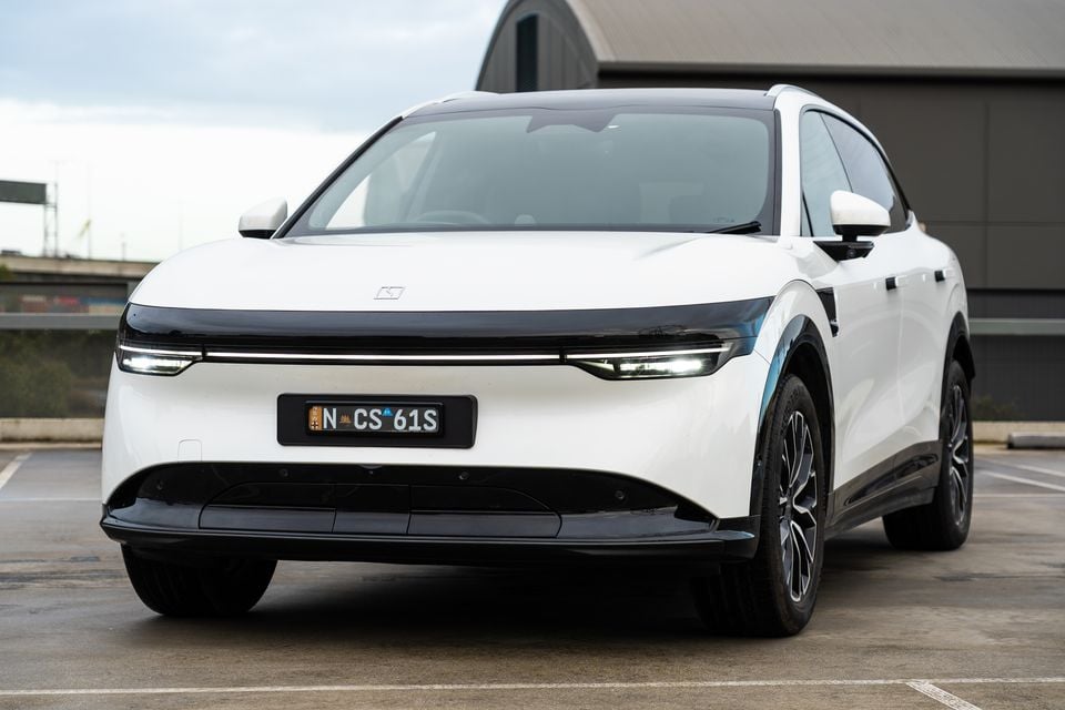 A white 2026 Zeekr 7X SUV seen from the front in a car park, with LED headlights illuminated and an Australian number plate visible