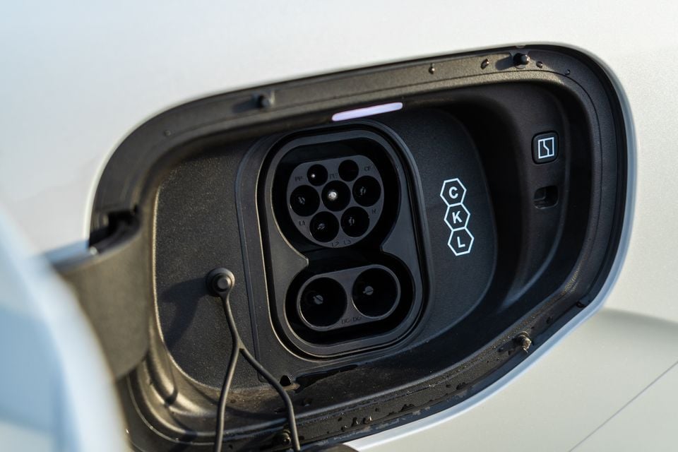 Close-up of the CCS Type 2 charging port on a white 2026 Zeekr 7X electric vehicle