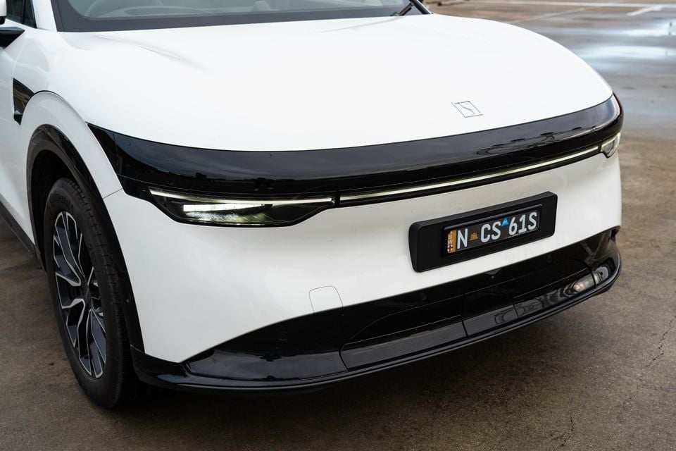Close-up of the front end of a white 2026 Zeekr 7X SUV, showing its slim LED headlights and front bumper, with a NSW number plate visible
