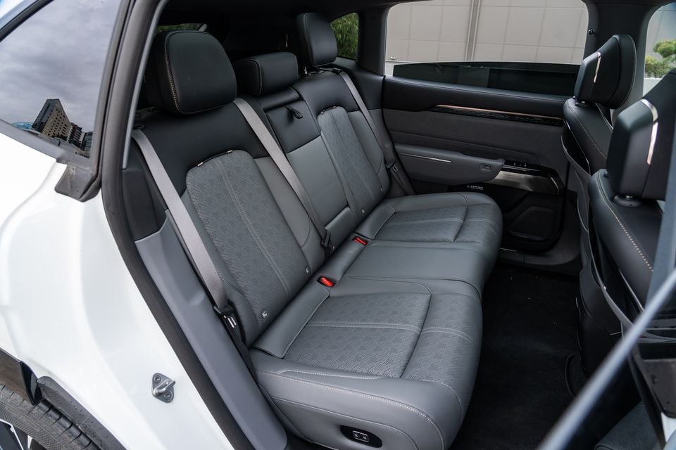 The rear interior of a 2026 Zeekr 7X showing grey leather rear seats with contrasting stitching and rear-seat controls