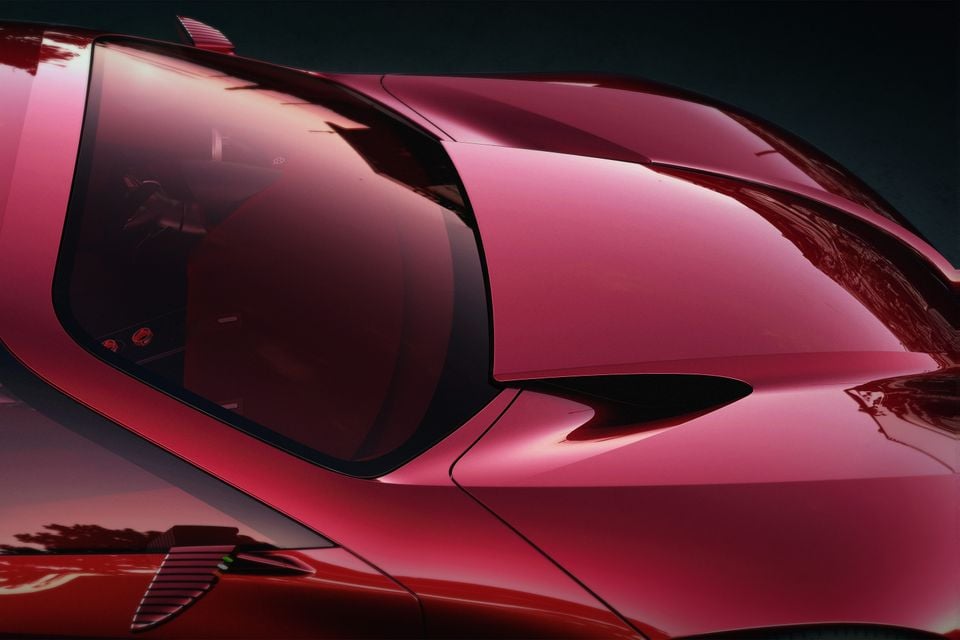Close-up of the red 2026 Alfa Romeo 33 Stradale-style supercar's side window, rear haunch and air intake in a dark studio