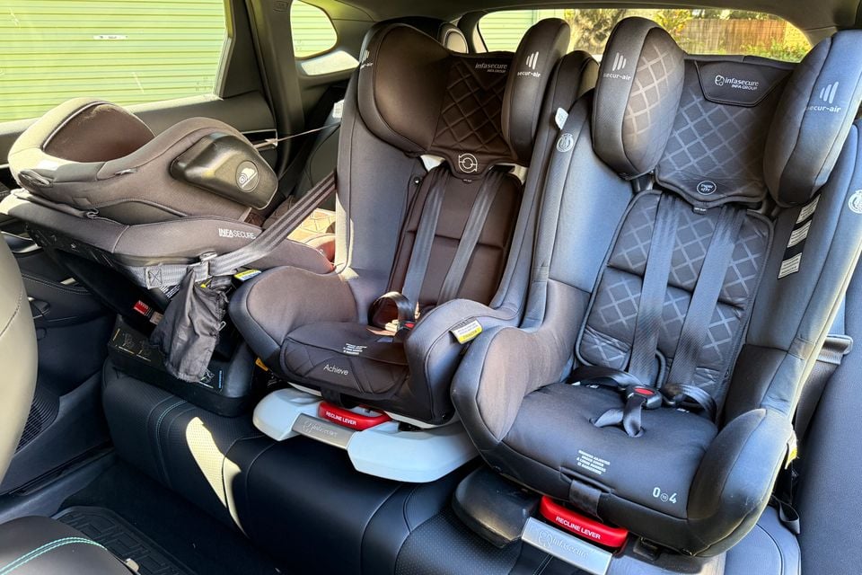 Three Infasecure child car seats fitted across the rear bench of a 2026 BYD Sealion 6, including a rearward-facing capsule and two forward-facing seats