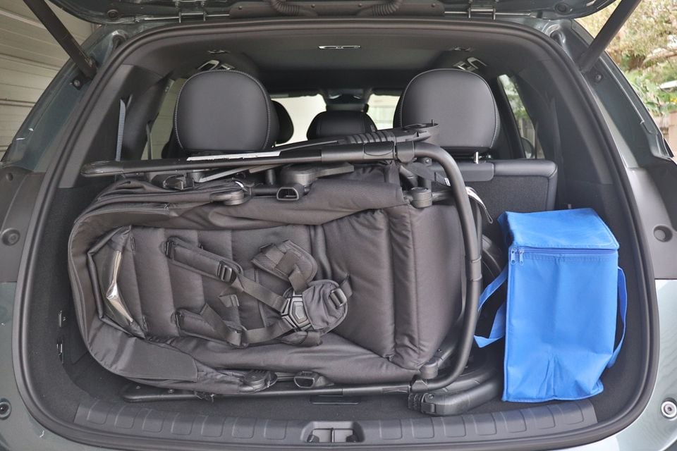 The cargo area of a BYD Sealion 8 loaded with a folded pram and a blue insulated bag