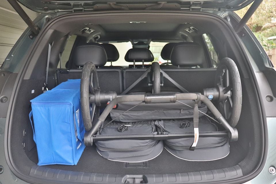 Boot of a 2026 BYD Sealion 8 SUV with the tailgate open, holding a folded pram and a blue cooler bag behind the third-row seats