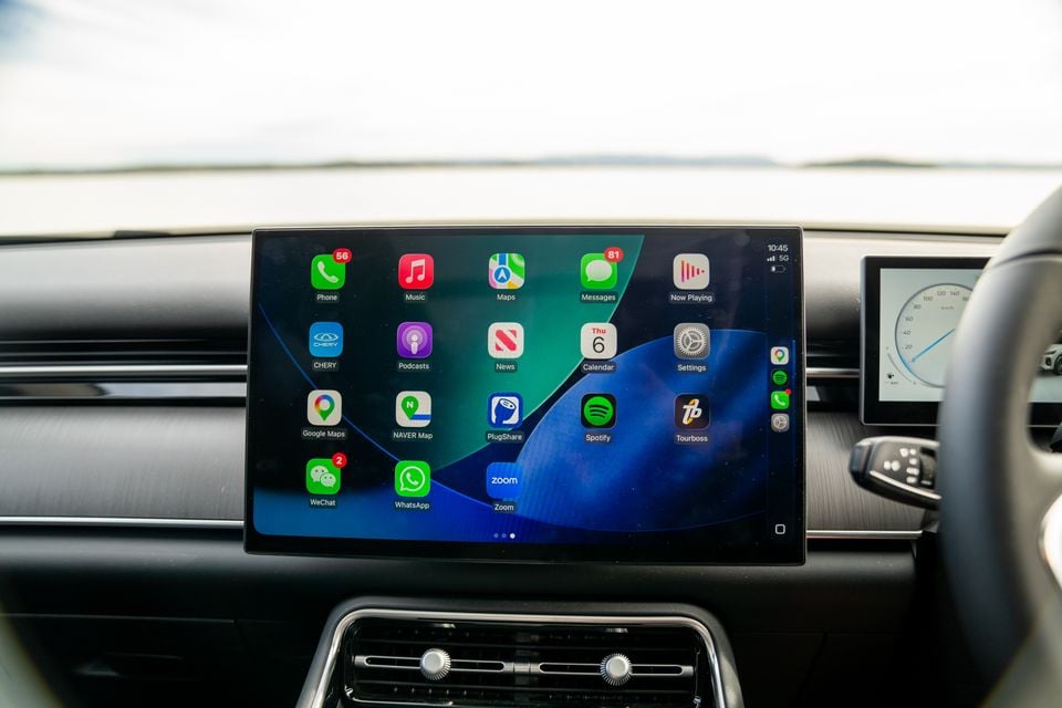 The touchscreen infotainment display in a Chery Tiggo 9 showing Apple CarPlay with apps including Phone, Music, Maps, Messages, Google Maps, Spotify, WhatsApp, and Zoom