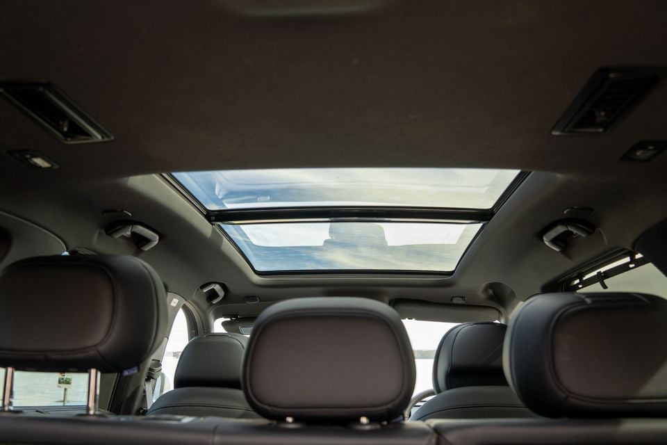 Interior view of a 2026 Chery Tiggo 9 showing the rear seating area with leather headrests and a large panoramic sunroof overhead
