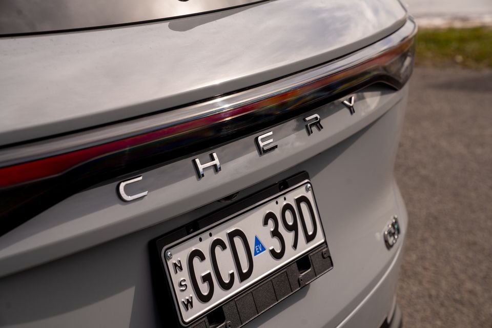 Close-up of the rear of a Chery Tiggo 9 showing the chrome letter badging and NSW EV number plate