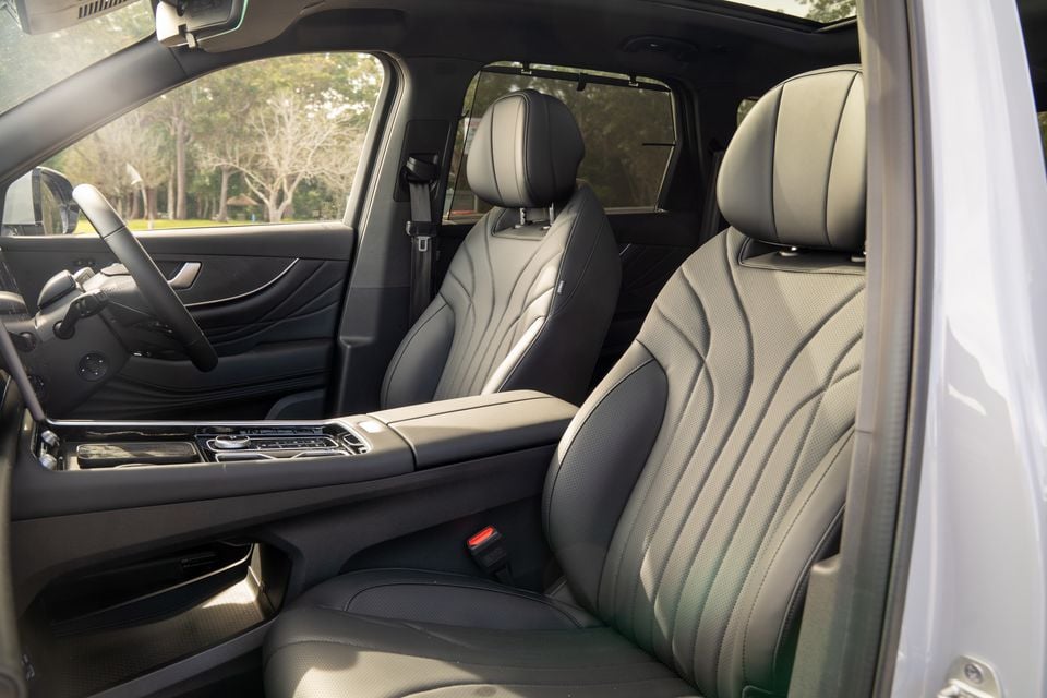 Black leather front seats and centre console inside a 2026 Chery Tiggo 9, viewed from the open passenger door