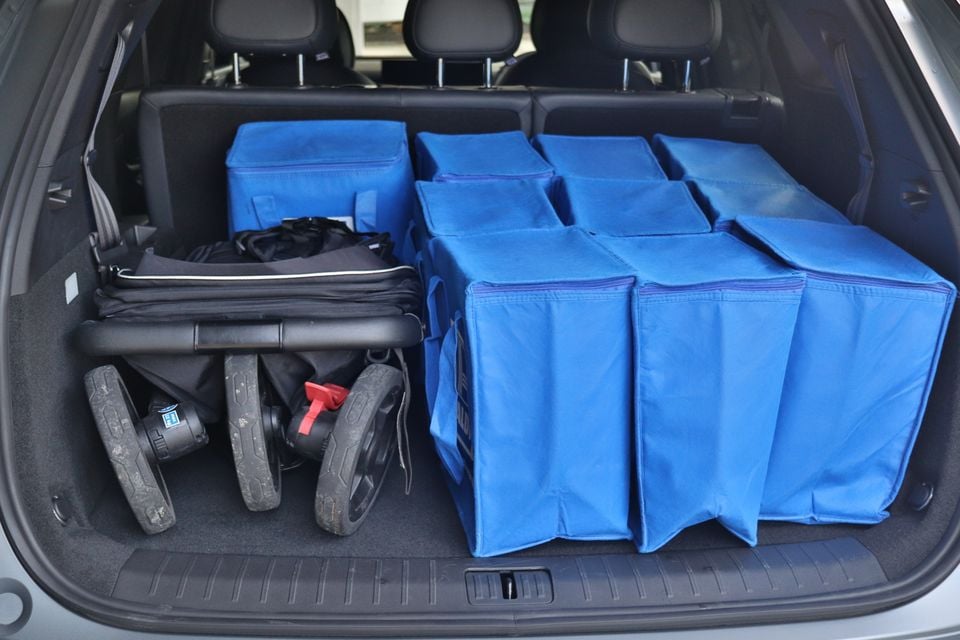 The boot of a 2026 Chery Tiggo9 SUV packed with blue storage bags and a folded pram