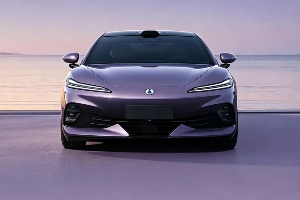 A purple 2026 Denza Z9S sedan seen from the front, parked against a calm waterfront backdrop at dusk.