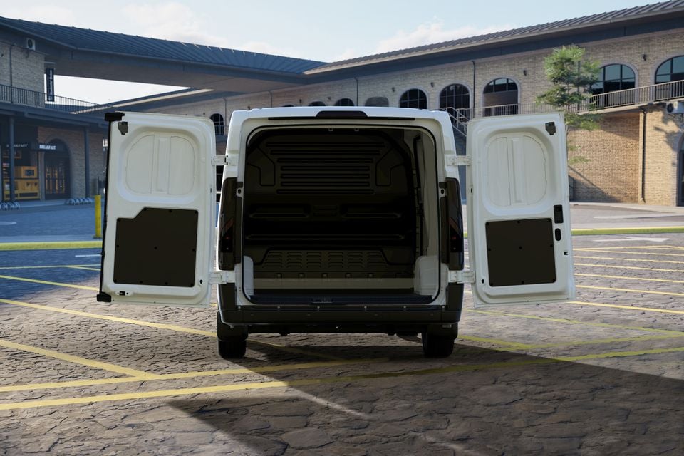 A white van seen from the rear with both cargo doors open wide, showing the empty load area, parked in an open car park