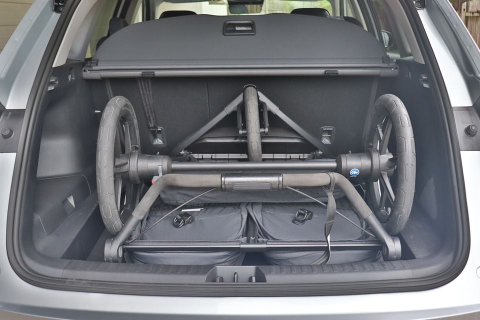 Open boot of a silver 2026 Geely Starray SUV holding a folded pram, with the cargo blind fitted above