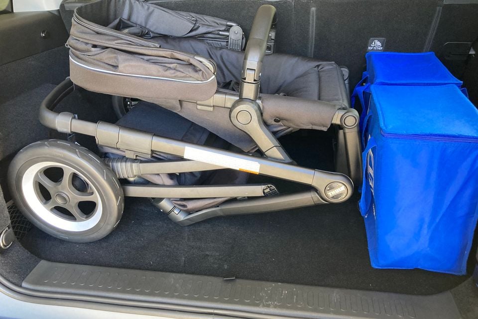 A folded Thule stroller and a blue insulated bag packed into the boot of a 2026 GWM Tank 300 PHEV