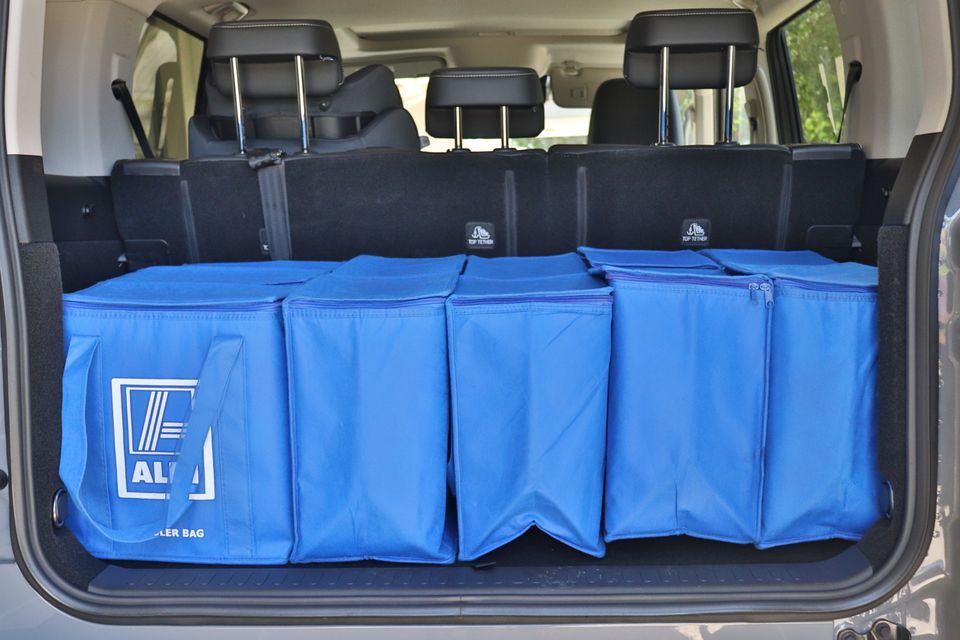 The boot of a 2026 GWM Tank 300 PHEV loaded with five blue Aldi cooler bags, seen from the open tailgate.
