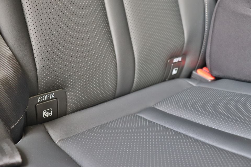 Close-up of the ISOFIX child seat anchor label between the rear seats of a 2026 GWM Tank 300 PHEV