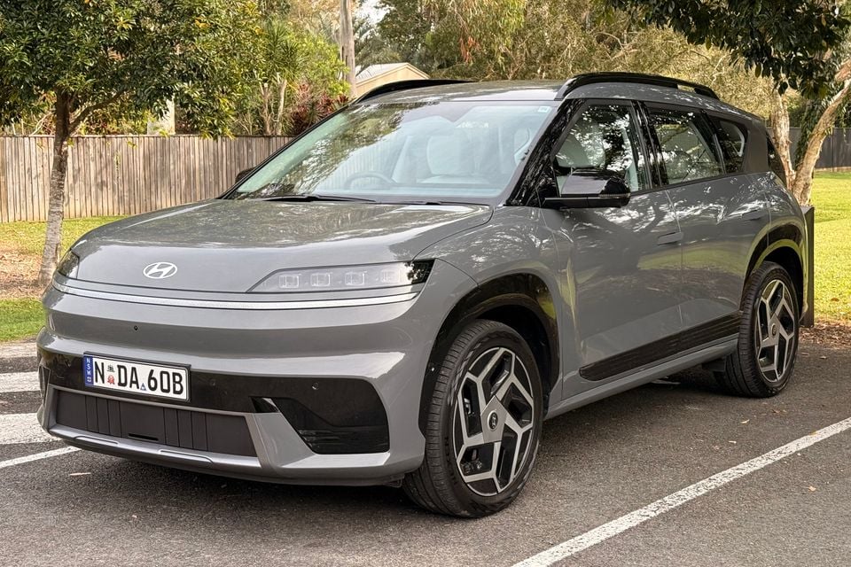 A grey Hyundai Ioniq 9 large electric SUV parked in a car park, seen from the front-left side