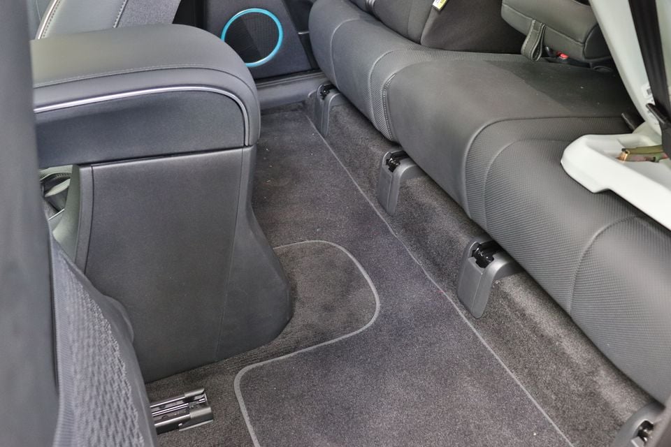 Interior view of a Hyundai Ioniq 5 showing the rear seat footwell area, carpet floor mats, and ISOFIX anchor points on the rear bench seat